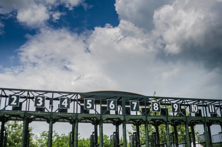 The gate for horse races empty on a summer afternoon